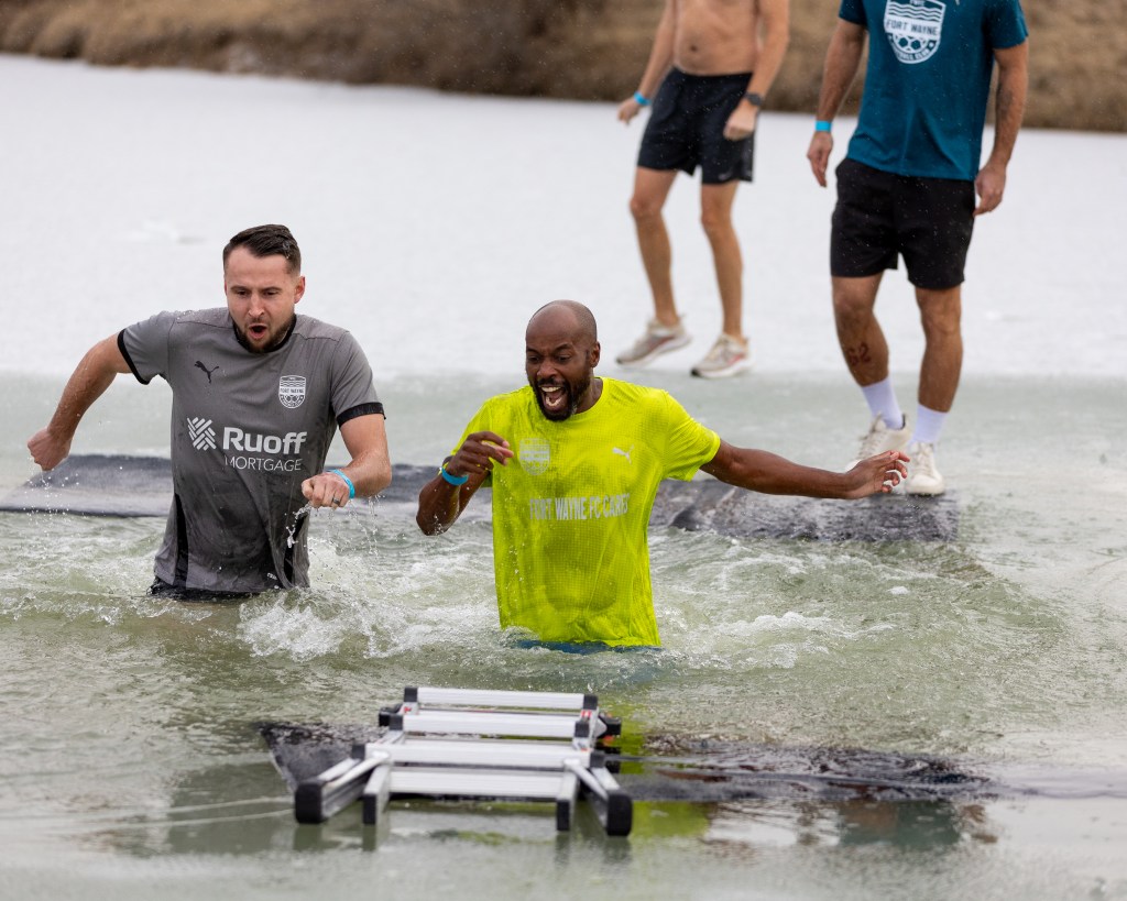 Fort Wayne FC's Director of Football Operations DaMarcus Beasley, right, and Assistant Coach Keelan Barker plunge into the Metea County Park waters to support Special Olympics Indiana